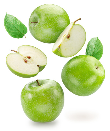 Green apple and green apples slices levitating in air isolated on white background. File contains clipping path.