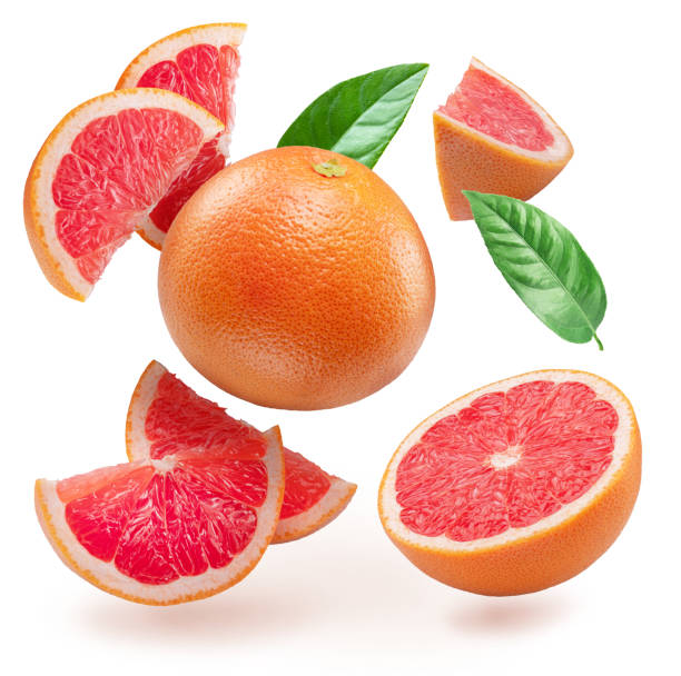 istock Red grapefruit and grapefruit slices levitating in air on white background. File contains clipping paths. 2149942635
