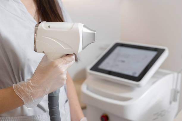 istock Cosmetologist hold in hand laser hair removal device 2149943015