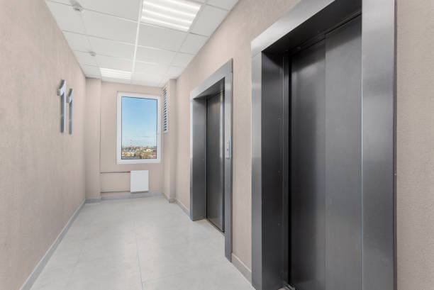 istock Building corridor with elevators and a window offering a city view. 2149943378