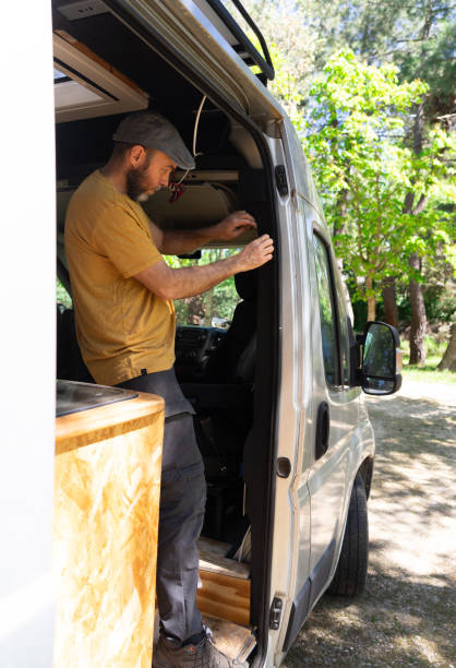 istock Man working putting a thermal insulator on a camper van 2149943618