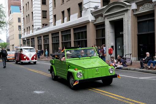 Norfolk, Virginia USA: April 20th 2024:  At the 75th anniversary of the NATO parade the different types of Volkswagen cars drive through the parade route.