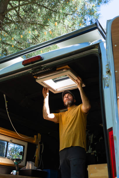 istock Man camperizing his camper van putting up a skylight 2149943629
