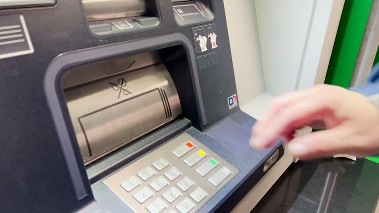 Close-Up Look at Man's Hands cover and typing password from ATM