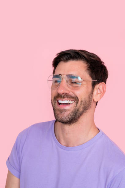 istock Joyful man with sunglasses on pink background 2149947658