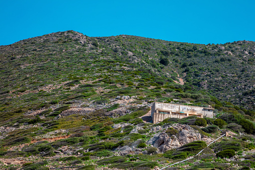 abandoned building on a hill, buildings belonging to an extinct mine in Buggerru, Sardinia, Italy