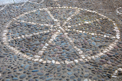white stones on the street arranged in the shape of sliced pizza, Sardinia, Italy