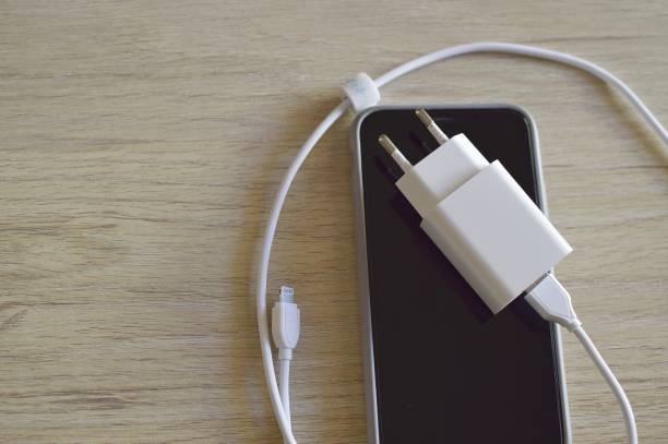 istock A mobile phone with a charger laying on the screen 2149953103