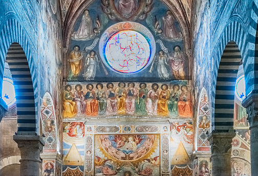 SAN GIMIGNANO, ITALY - JUNE 21: Interior of the Collegiate Church of Santa Maria Assunta, iconic basilica and major landmark in the historic centre of San Gimignano, Italy, June 21, 2019