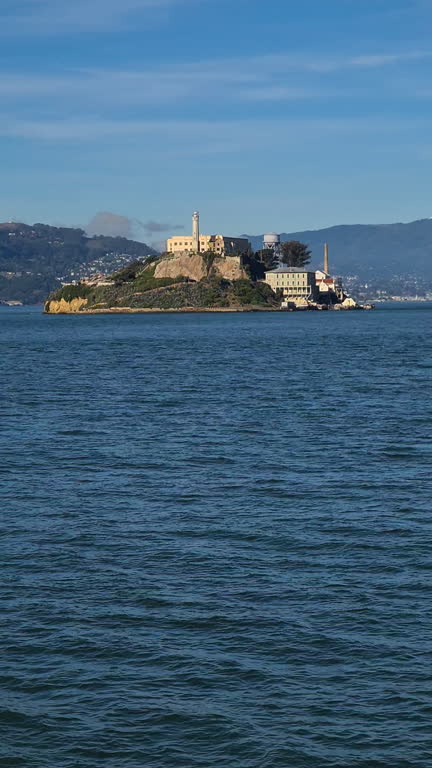 Vertical Video, Alcatraz Island and Former Prison Building Seen From Ferry Boat Sailing in San Francisco Bay