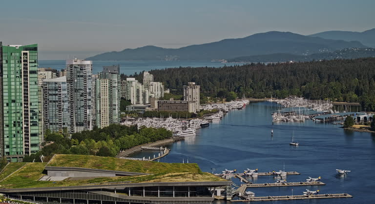 Vancouver BC Canada Aerial v96 zoomed drone flyover landmark Canada Place capturing waterfront downtown cityscape, Coal Harbour Marina and Stanley Park views - Shot with Mavic 3 Pro Cine - July 2023