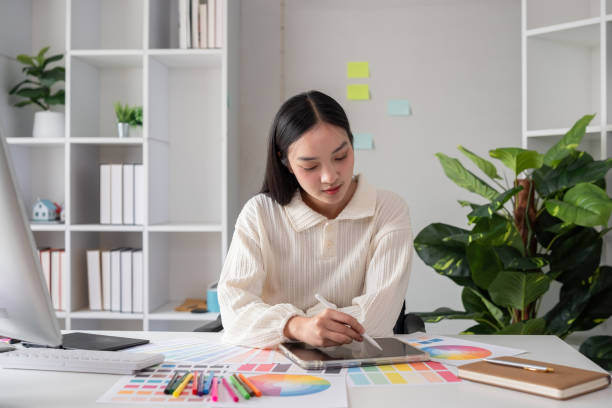 istock Female designer working in graphic design Choose colors for working on tablets and computer designs. 2149957005