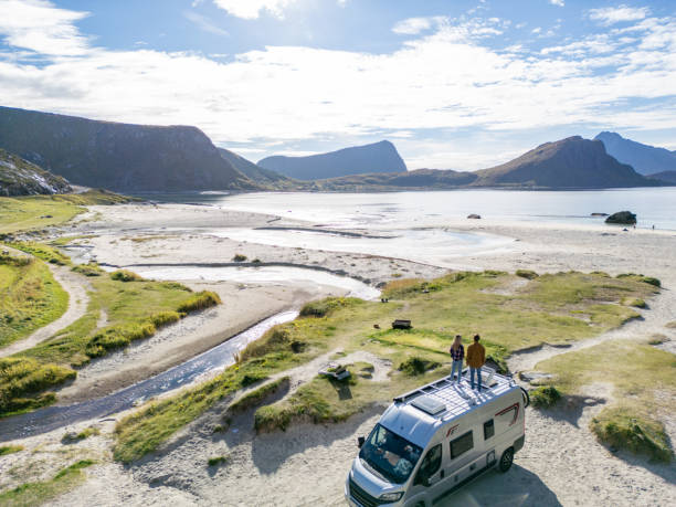 istock A couple standing on top of a camper van 2149959566