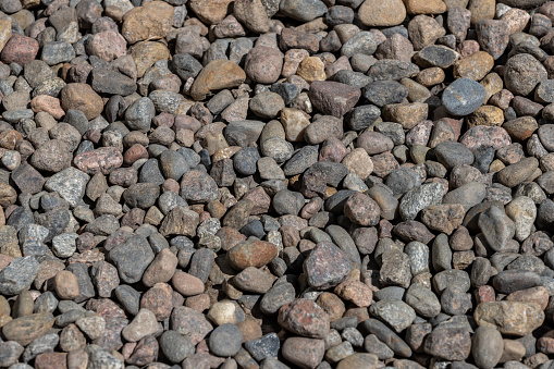 A multitude of stones in various shades in the light.