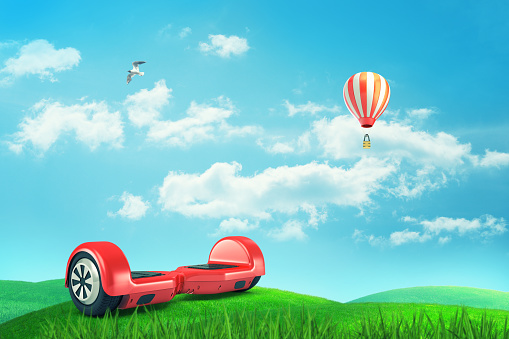 3d rendering of red self-balancing scooter on green meadow under blue sky with white clouds, white bird and striped hot air balloon. Sports equipment. Eco-friendly transportation. Outdoor activities.