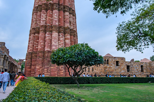 Delhi, India - March 11 2024: The Qutub Minar at Delhi India. The height of Qutub Minar is 72.5 meters, making it the tallest minaret in the world built of bricks.