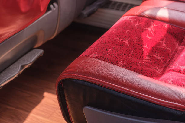 Close-up of an empty red bus seat.
