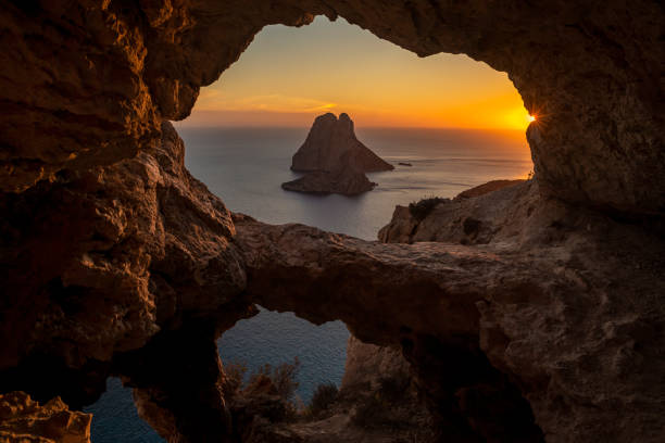 istock Es Vedra islet view through a cave hole at sunset 2149963276