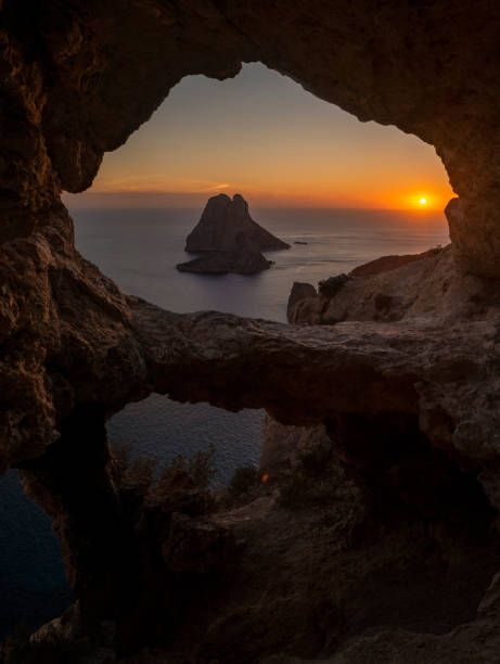 istock Es Vedra islet view through a cave hole at sunset 2149963287