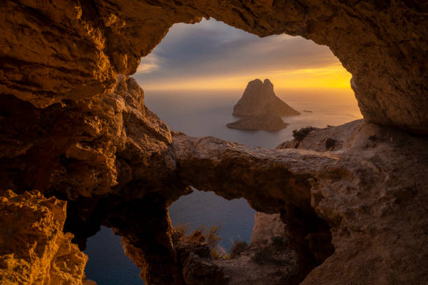 istock Es Vedra islet view through a cave hole at sunset 2149963818