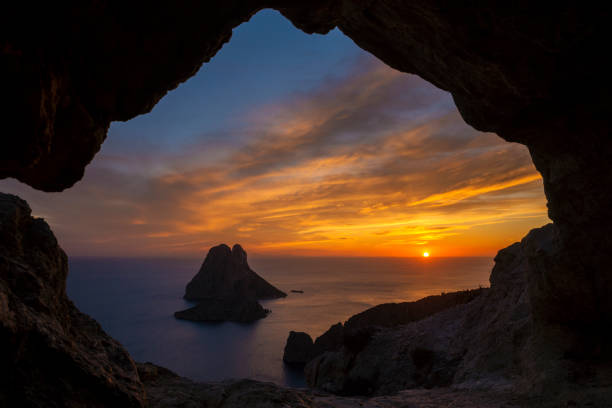 istock Es Vedra islet view through a rock hole at sunset 2149964089