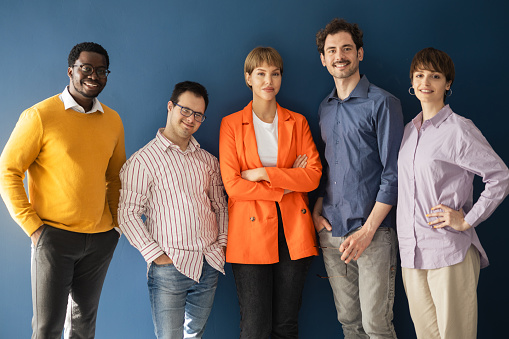 Studio portrait of a diverse business team, with a member with Down syndrome.
