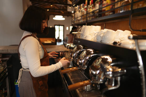 istock Female barista making coffee in a local cafeteria 2149966148