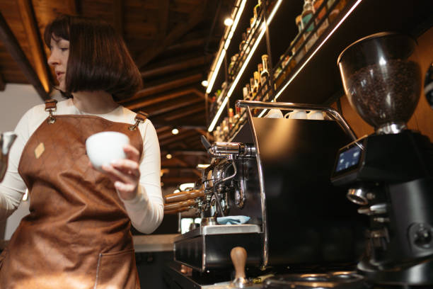 istock Female barista making coffee in a local cafeteria 2149966150