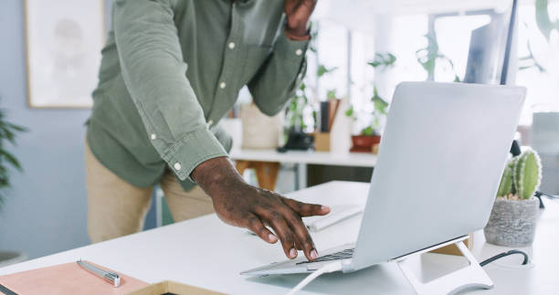 istock Hand, laptop and phone call with office, typing and network for b2b conversation. African business consultant, technology and communication with person, email and planning for workplace connection 2149968397