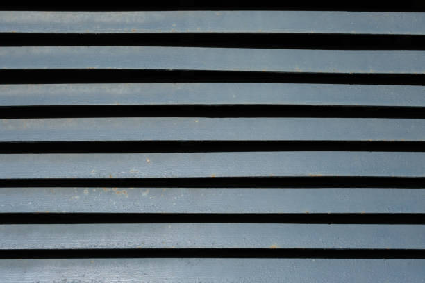 Close-up on gray metal vents to allow the passing of air.