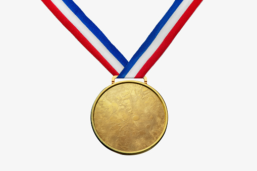 A real gold medal isolated on free white background with a lot of text area - winner copy space concept