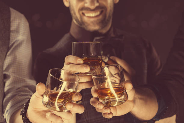 istock Men drinking whiskey, close up of glasses and hands 2149970185