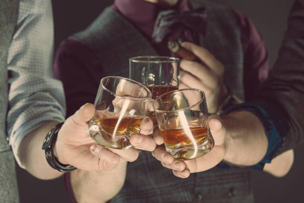 istock Men drinking whiskey, close up of glasses and hands 2149970206