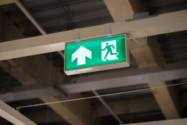 istock Exit Sign banner with lighting on the wall over walkway in building 2149971886