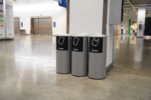 istock Trash cans with signs to classify waste types in building 2149971898