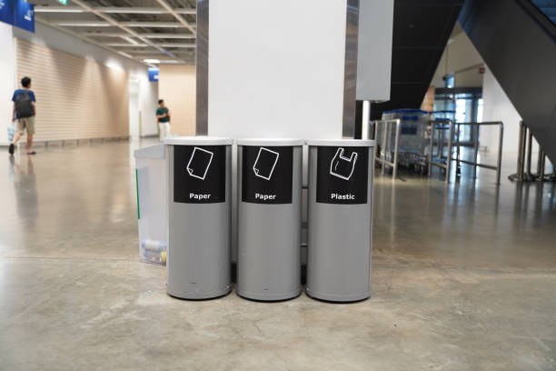 istock Trash cans with signs to classify waste types in building 2149971900