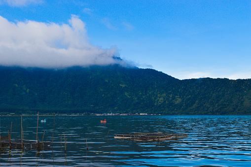 View Of Lake Water Waves And Mountains Shrouded In Clouds After The Rain At Beratan Lake, Bedugul, Bali, Indonesia