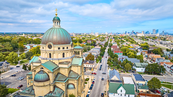 Aerial view of the historic Basilica of St Josaphat in Milwaukee, Wisconsin showcasing unique dome architecture, tranquil cityscape, and integrated urban nature.