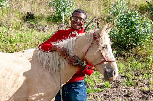 A joyful rider enjoying a sunny day on horseback in the countryside.