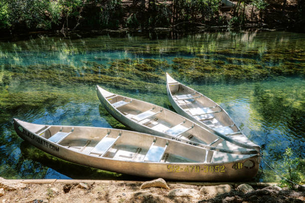 istock Three canoes on clear lake. 2149976181