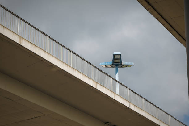 a highway bridge with a floodlight in the background