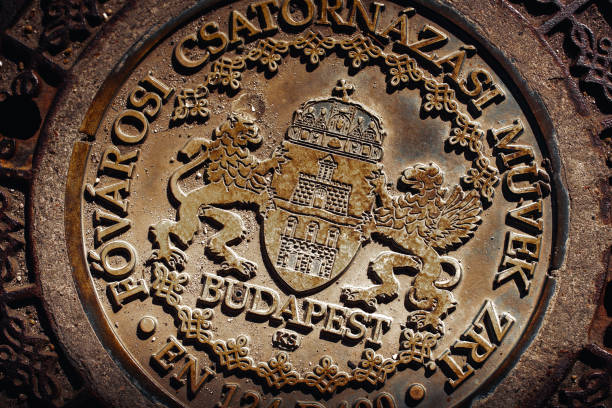 Sightseeing at the old town of City of Ljubljana with close-up of beautiful manhole cover of telecommunications tube on a cloudy summer day. Photo taken August 9th, 2023, Ljubljana, Slovenia.