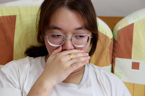 Portrait of an Asian teenage girl yawning