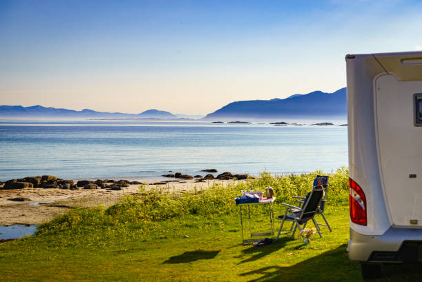 istock Camping on fjord. Camper and chairs 2149985101