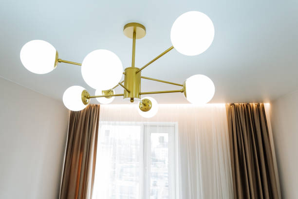 istock A chandelier hangs from ceiling in a room adorned with a window 2149985312