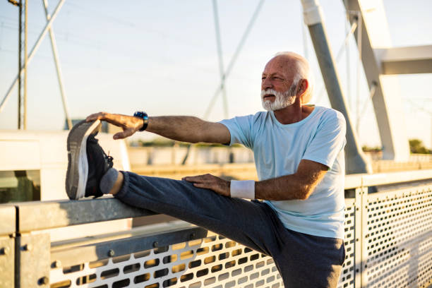 istock Senior man stretching while jogging. Active senior man stretching before running. Exercise, balance and man stretching legs. 2149985592
