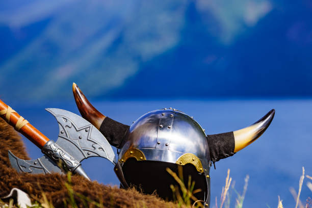 Viking helmet with axe on fjord shore in Norway. Tourism and traveling concept