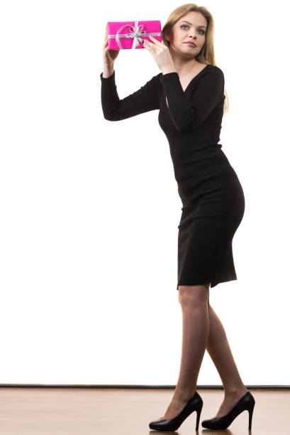 Profile view of cool young blond woman dancing against powder blue background.