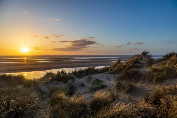istock Sunset at the beach, with marram grass covered sand dunes in the foreground 2149986138