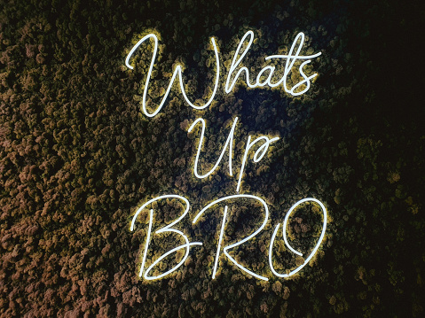 Whats up bro neon text decoration in a wall
